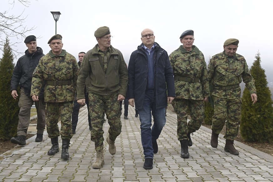 In this photo provided by the Serbian Defense Ministry Press Service, Serbia Defense Minister Milos Vucevic, center, speaks with Serbian army chief of staff Milan Mojsilovic, center left, at the army  ...