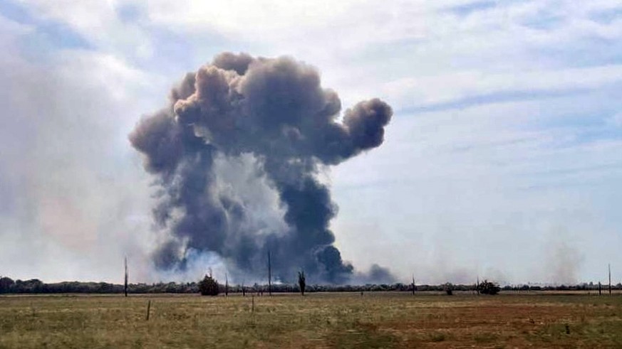 epa10112853 A handout picture made available by the Department of Information and Press Service of the Head of the Republic of Crimea shows smoke rising after detonations of air munisions at the Saki  ...