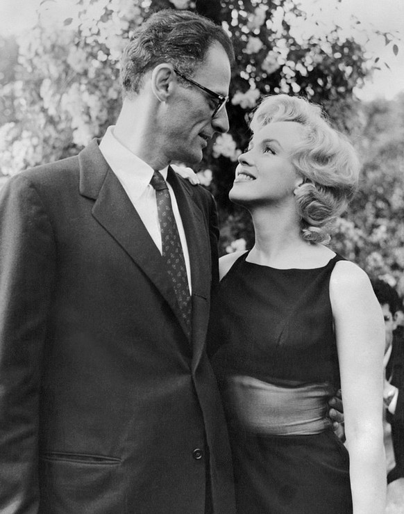 (Original Caption) Marilyn Monroe and her husband, Arthur Miller in the grounds of Lord Moore's luxury home, Parkside House, Englefield Green, Surrey, which they are renting.