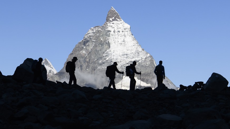 epa09473564 Festival-goers come down after a concert of the French Band Tournee des Refuges the day before at the Monte Rosa Hut (2,883m), with a view of Cervin (Matterhorn) Mountain, during the Zerma ...