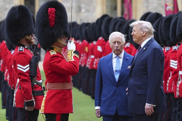 President Donald Trump and Britain&#039;s King Charles III review the Guard of Honour after the arrival at Windsor Castle in Windsor, England, Wednesday, Sept. 17, 2025.(AP Photo/Kirsty Wigglesworth,  ...