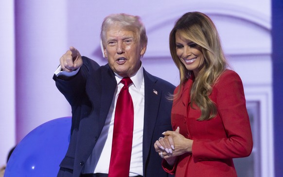 epa11486922 Republican presidential nominee Donald J. Trump (L) and Melania Trump (R) react on stage at the end of the Republican National Convention (RNC) at Fiserv Forum in Milwaukee, Wisconsin, USA ...