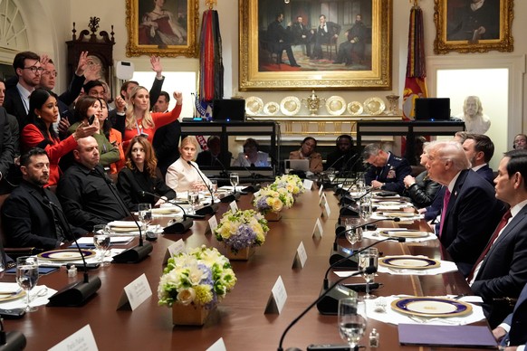 President Donald Trump, second right, and Ukraine&#039;s President Volodymyr Zelenskyy, seated left, sit as reporters ask questions before a lunch in the Cabinet Room of the White House, Friday, Oct.  ...