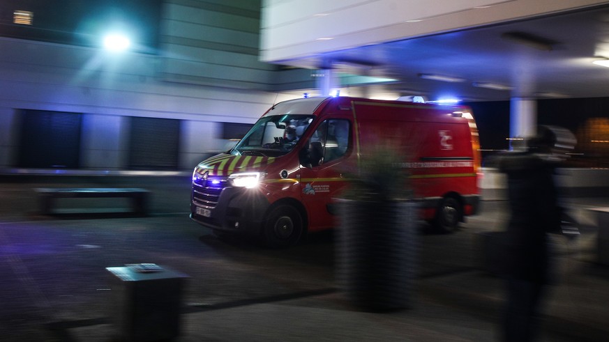 epa09601870 An ambulance arrives at the emergency entrance at Calais Hospital Center, in Calais, France, 24 November 2021. At least 31 migrants are dead and two more were brought to the hospital after ...