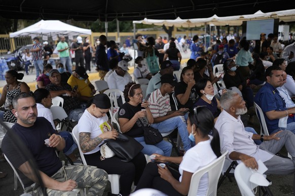 Family members wait to receive the remains of their loved one who died at the Jet Set nightclub days after its roof collapsed, killing more than 200 people, at the National Institute of Forensic Patho ...
