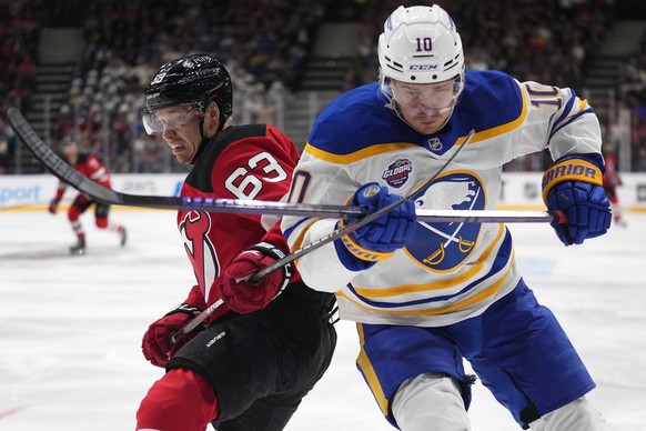 New Jersey Devils&#039; Jesper Bratt, left, challenges Buffalo Sabres&#039; Henri Jokiharju during the NHL hockey game between Buffalo Sabres and New Jersey Devils, in Prague, Czech Republic, Saturday ...