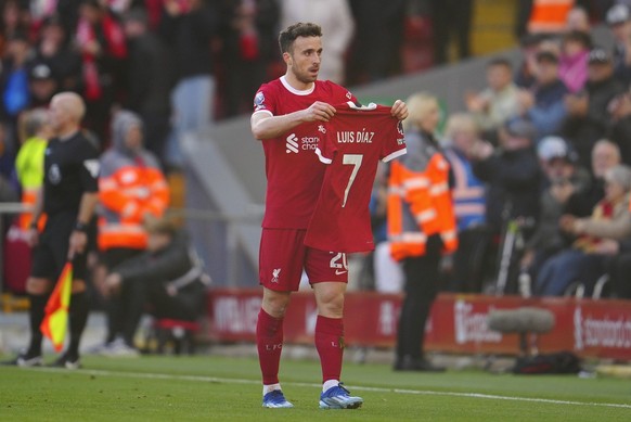 Liverpool&#039;s Diogo Jota celebrates after scoring his side&#039;s opening goal holding the jersey of teammate Luis Diaz during the English Premier League soccer match between Liverpool and Nottingh ...