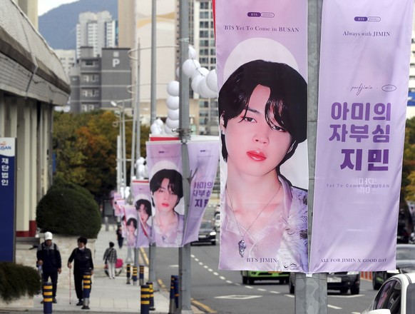 Banners featuring Jimin, a member of South Korean K-pop band BTS, are displayed along a road near Busan Asiad Main Stadium in Busan, South Korea Wednesday, Oct. 12, 2022, three days before the boy ban ...