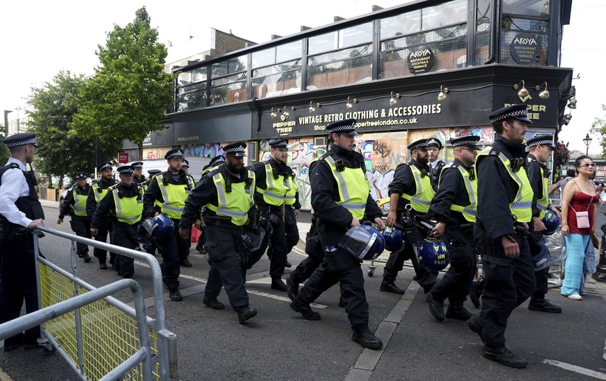 Police officers on Ladbroke Grove as the Notting Hill Carnival takes place, in west London, Monday, Aug. 26, 2024. (Lucy North/PA via AP)