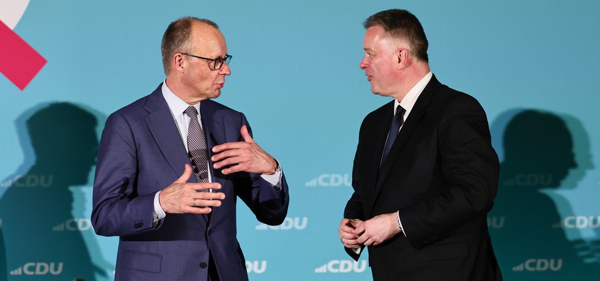 epa12836990 Christian Democratic Union (CDU) top regional candidate for the 2026 state elections in Rhineland-Palatinate Gordon Schnieder (R) and German Chancellor Friedrich Merz speak during a campai ...