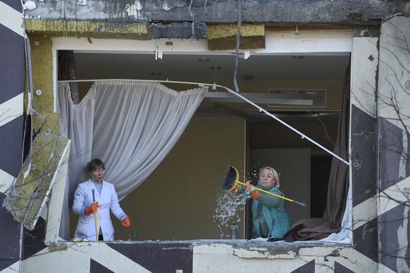 Medical workers remove the debris in a damaged private clinic after, according to Ukrainian officials, a Russian drone hit a hospital room killing a patient, in Kyiv, Ukraine, Monday, Jan 5, 2026. (AP ...