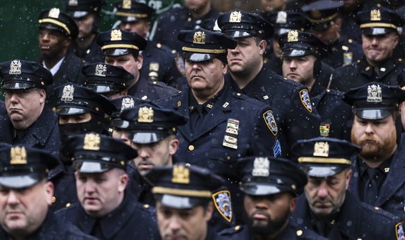 epa09714926 Police officers gathered on Fifth Avenue listen to funeral services for slain New York City police officer Jason Rivera outside of St. Patrick?s Cathedral in New York, New York, USA, 28 Ja ...