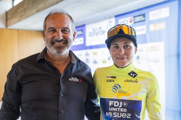 The winner of The Tour de Romandie Feminin Elise Chabbey, right, from Switzerland of team FDJ - Suez, and Richard Chassot, left, director of the Tour de Romandie, poses for the photographer after the  ...