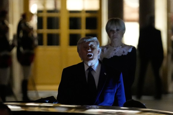 epa13045482 US President Donald Trump (C) departs after a dinner at the Palace of Versailles, Versailles, France, 18 June 2026, as French First Lady Brigitte Macron (R) stands behind. EPA/Michel Euler ...
