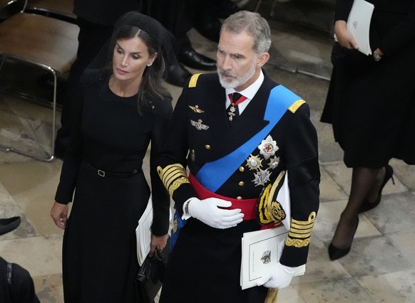 Spain&#039;s King Felipe VI and Queen Letizia walk together after the coffin of Queen Elizabeth II is carried out of Westminster Abbey during her funeral in central London, Monday, Sept. 19, 2022. The ...