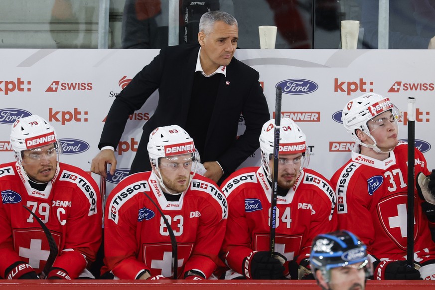Switzerland's head coach Jan Cadieux reacts next to his players Calvin Thuerkauf, Dario Meyer, Lorenzo Canonica and Miles Mueller, from left, during a friendly ice hockey match between Switzerlan ...