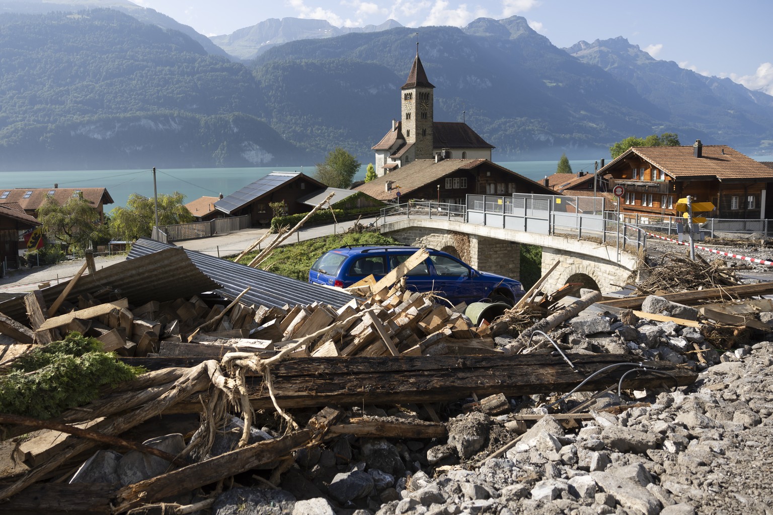 Felsbloecke, Steine und Holz von einer Geroelllawine liegen zwischen den Haeusern, am Freitag, 16. August 2024 in Brienz im Berner Oberland. Am Montag Abend haben heftige Gewitter einen Murgang ausgel ...