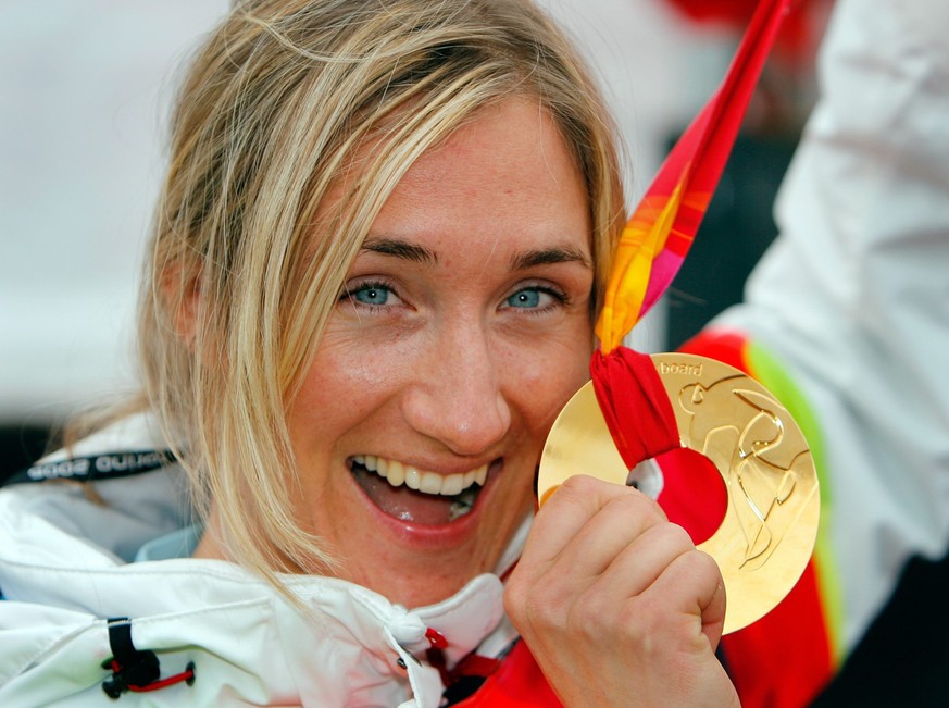 Swiss Tanja Frieden with the gold medal of her boyfriend US Snowboard Cross winner Seth Wescott, after winning the Womens Snowboard Cross at the Turin 2006 Winter Olympic Games, in Bardonecchia, Italy ...