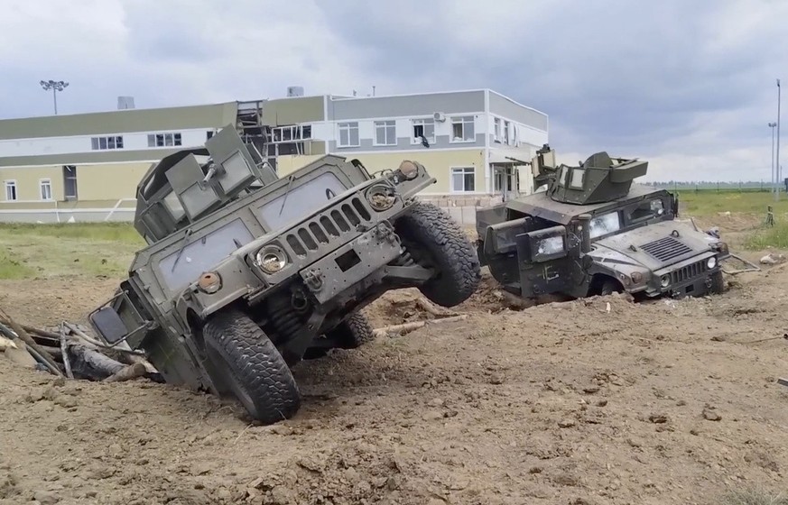 epa10648879 A still image taken from a handout video made available by the Russian Defence Ministry Press-Service shows destroyed armored fighting vehicles in the Grayvoronsky district of Belgorod reg ...