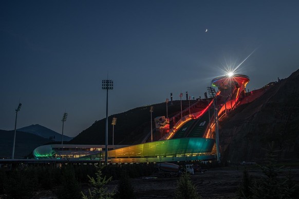 epa09344266 A light show is seen from the National Ski Jumping Centre, one of the venues for Beijing 2022 Olympic and Paralympic Winter Games, during a media tour in Zhangjiakou, Hebei province, China ...