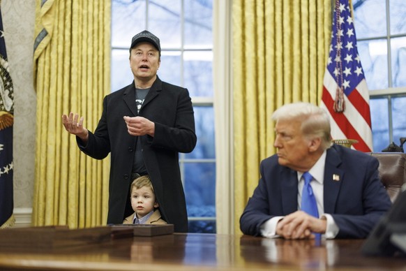 epa11889366 US entrepreneur and U.S. special government employee Elon Musk (L), with his son X, and US President Donald J. Trump (R) talk to media in the Oval Office of the White House in Washington, ...