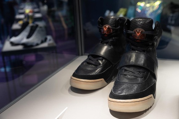 epa09140797 Kanye West &#039;Grammy Worn&#039; Nike Air Yeezy 1 Prototype sneakers (R) are on display during a Sotheby&#039;s auction preview in Hong Kong, China, 17 April 2021. The shoes, worn by Wes ...