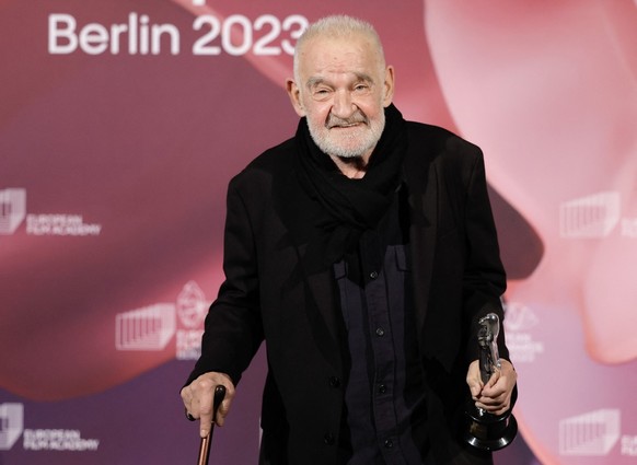(FILES) Hungarian film director and screenwriter Bela Tarr poses with his honorary award trophy during the 36th European Film Awards ceremony in Berlin, on December 9, 2023. Legendary Hungarian filmma ...