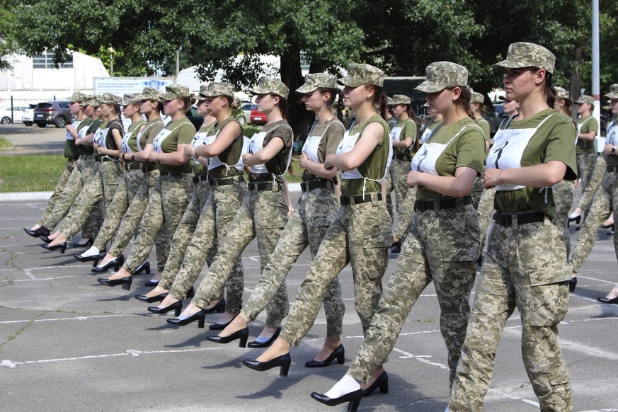 In this photo taken and released by the Ukrainian Defense ministry press-service on July 2, 2021, Ukrainian female soldiers wear heels while taking part in the the military parade rehearsal in Kyiv, U ...