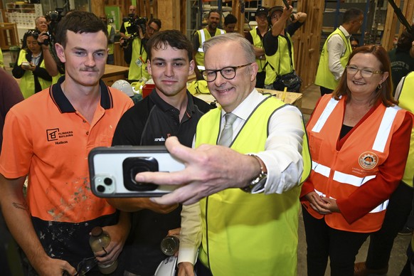 Australian Prime Minister Anthony Albanese, center, takes a selfie with apprentice carpenters while visiting Technical and Further Education (TAFE) Tonsley campus in Adelaide, Thursday, May 1, 2025. ( ...
