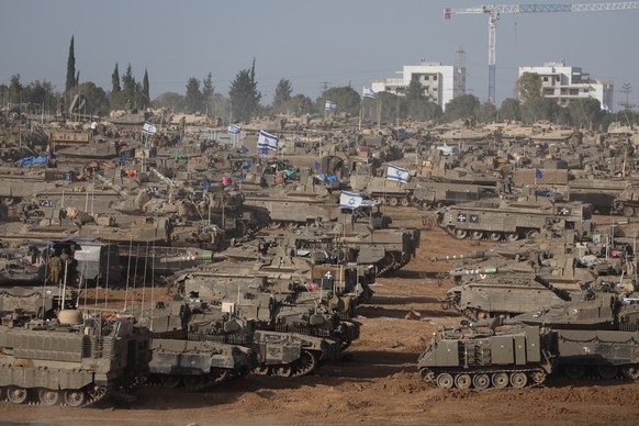epa11329418 Israeli military vehicles gathered near the border fence with the Gaza Strip, at an undisclosed location in southern Israel, 09 May 2024. On 07 May, Israel said that its troops began an op ...