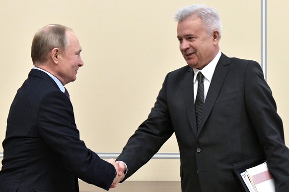 FILE �?? Russian President Vladimir Putin, left, shakes hands with Lukoil President Vagit Alekperov during a meeting at the Novo-Ogaryovo residence outside Moscow in Moscow, Russia, Jan. 28, 2020. (Al ...