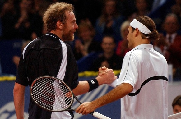 Switzerland&#039;s Marc Rosset, left, congratulates his opponent, Switzerland&#039;s Roger Federer to his victory after their first round game at the Swiss Indoors in Basel, Tuesday 21, October 2003.  ...
