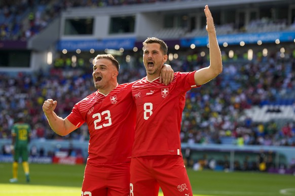 Switzerland's Xherdan Shaqiri, left, and Switzerland's Remo Freuler celebrate first goal during the World Cup group G soccer match between Switzerland and Cameroon, at the Al Janoub Stadium in Al Wakr ...