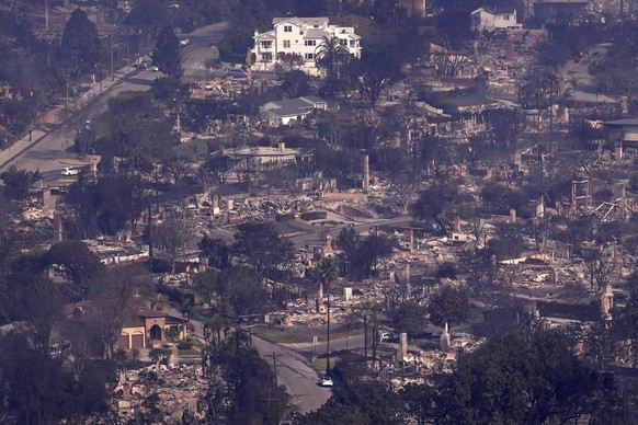 Homes are seen burned while a few still stand, Thursday, Jan. 9, 2025, in the Pacific Palisades section of Los Angeles. (AP Photo/Mark J. Terrill)