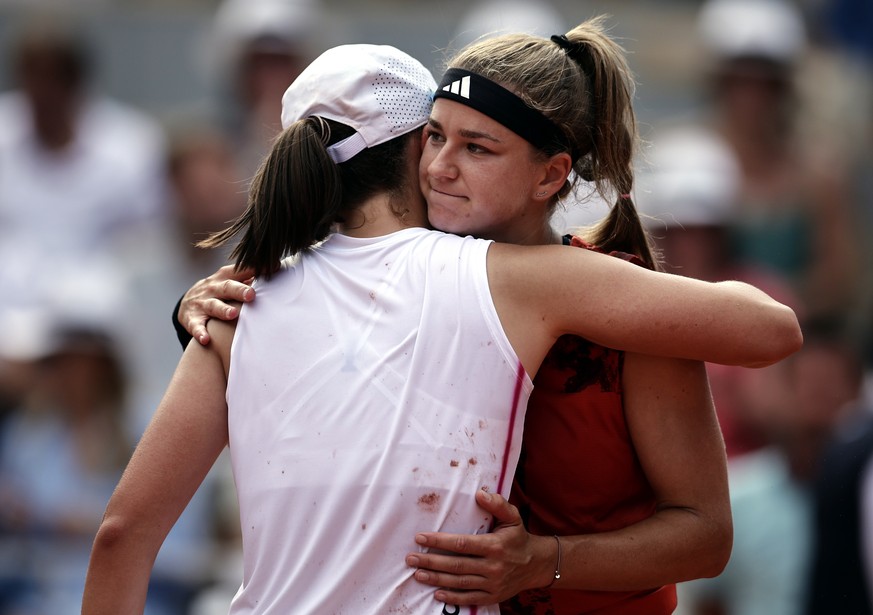 epa10683752 Iga Swiatek of Poland (L) reacts with Karolina Muchova of the Czech Republic after winning their Women&#039;s final match during the French Open Grand Slam tennis tournament at Roland Garr ...