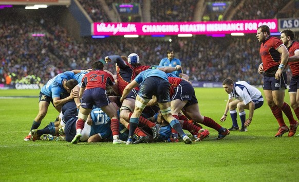 epa04641914 Referee George Clancy (C-R) allows the final charge for the final try during the Six Nations Rugby International match between Scotland and Italy at Murrayfield Stadium in Edinburgh, Brita ...