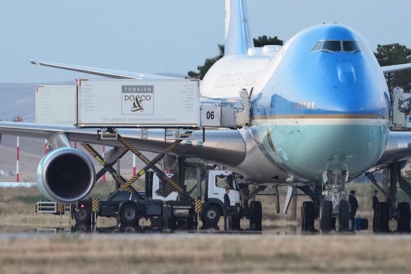 Catering trucks are parked at Air Force One on the tarmac as the motorcade carrying U.S. President Donald Trump arrives to depart following the NATO summit at Ankara International Airport in Ankara, T ...