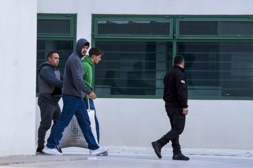 Police escort French rugby players Oscar Jegou, third from left, and Hugo Auradou, front, from jail after being given house arrest in Mendoza, Argentina, Wednesday, July 17, 2024. The players were arr ...