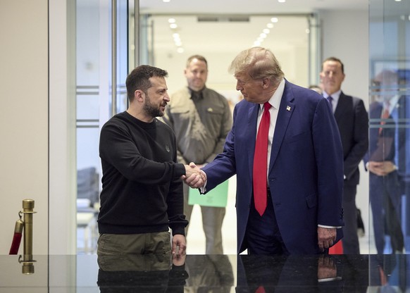 epa11629044 A handout picture made available by the Ukraine Presidential Press Service shows Ukrainian President Volodymyr Zelensky (L) and Republican presidential candidate Donald J. Trump (R), shake ...