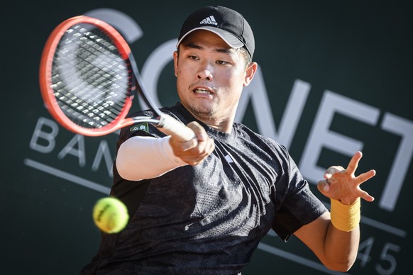 Yibing Wu of China, returns a ball to Marc-Andrea Huesler of Switzerland, during their first round match, at the ATP 250 Geneva Open tournament, Monday, May 22, 2023 in Geneva, Switzerland. (KEYSTONE/ ...