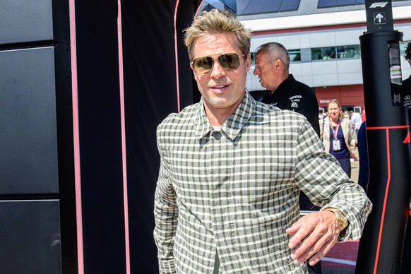Actor Brad Pitt walks through the paddock before the British Formula One Grand Prix race at the Silverstone racetrack, Silverstone, England, Sunday, July 9, 2023. Production of Brad Pitt and Lewis Ham ...