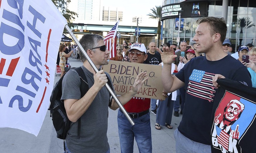 A supporter of President Joe Biden, left, argues with supporters of former President Donald Trump outside the Amway Center in Orlando, Fla., on Sunday, Dec. 12, 2021, before the start of the Donald Tr ...