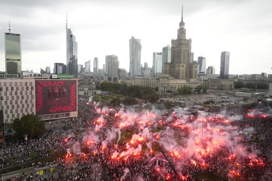 People light flares in Poland&#039;s capital as the country marks the 79th anniversary of the start of the Warsaw Uprising, a doomed revolt against the occupying Germans during World War II, in Warsaw ...