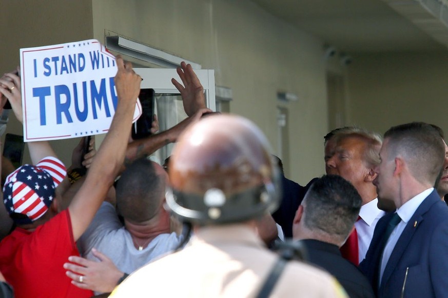 MIAMI, FLORIDA - JUNE 13: Former U.S. President Donald Trump waves as he makes a visit to the Cuban restaurant Versailles after he appeared for his arraignment on June 13, 2023 in Miami, Florida. Trum ...