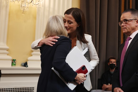 epa10039562 Cassidy Hutchinson, a former aide to White House Chief of Staff Mark Meadows (R) is embraced by Vice Chair and Republican Representative Liz Cheney of Wyoming (L) as she departs after conc ...