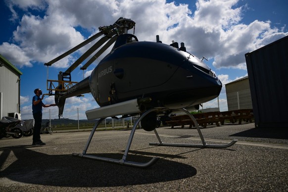 An employee inspects an Airbus VSR700 uncrewed aerial system (UAS) helicopter drone at the Survey Copter factory, an Airbus subsidiary in Pierrelatte, southern France on March 31, 2026. At Survey Copt ...