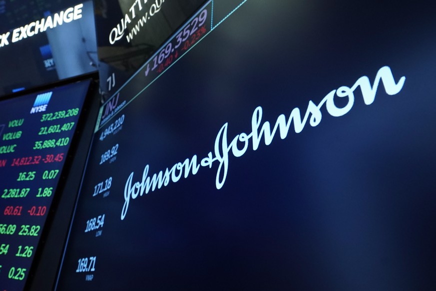 FILE - The Johnson &amp; Johnson logo appears above a trading post on the floor of the New York Stock Exchange on July 12, 2021. Johnson &amp; Johnson is earmarking nearly $9 billion to cover allegati ...