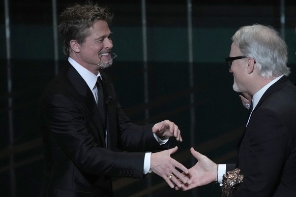 U.S. director David Fincher, right, shakes hand with Actor Brad Pitt after receiving the Cesar of Honor during the 48th Cesar Award ceremony on Friday, Feb. 24, 2021, in Paris. (AP Photo/Christophe En ...