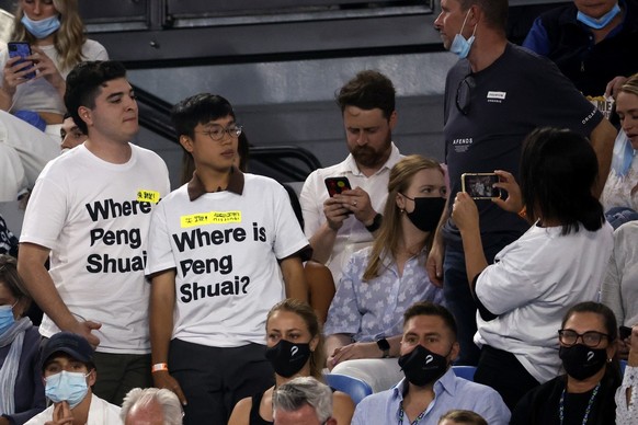 Supporters of Chinese tennis player Peng Shuai wear T-shirts as they pose for a photo during the women&#039;s final at the Australian Open tennis championships in Melbourne, Australia, Saturday, Jan.  ...