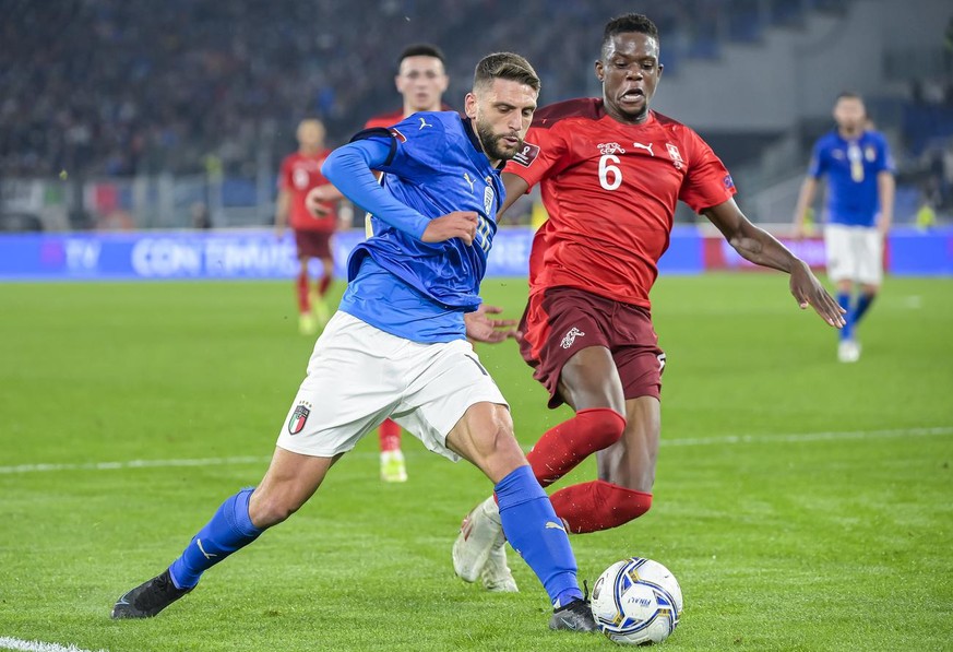 Italy&#039;s forward Domenico Berardi, left, fights for the ball with Switzerland&#039;s defender Denis Zakaria, right, during the 2022 FIFA World Cup European Qualifying Group C match between Italy a ...